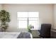 Bright bedroom space featuring a well-lit desk area, a large window, and a stylish decorative tree at 5917 Black Forest Dr, Elizabeth, CO 80107