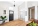 Bright entryway with hardwood floors, coat closet, and modern lighting fixtures that create a warm welcome at 5917 Black Forest Dr, Elizabeth, CO 80107