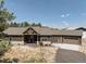 A charming ranch-style home showcases a welcoming front porch, attached garage, and neutral exterior colors at 5917 Black Forest Dr, Elizabeth, CO 80107