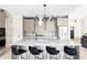 Contemporary kitchen with island seating, sleek cabinetry, stainless steel appliances, and modern backsplash at 5917 Black Forest Dr, Elizabeth, CO 80107