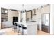 A gourmet kitchen with quartz countertops, a stylish backsplash, stainless steel appliances, and modern pendant lighting at 5917 Black Forest Dr, Elizabeth, CO 80107