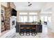 Cozy living room with a stone fireplace, modern decor, and an open layout perfect for entertaining and relaxation at 5917 Black Forest Dr, Elizabeth, CO 80107