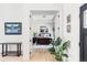 Bright main bedroom with light wood flooring and a decorative accent table with a beautiful display of mountain art at 5917 Black Forest Dr, Elizabeth, CO 80107