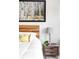 Close up on a main bedroom with a wood headboard, cozy bedding, and stylish nightstand decor at 5917 Black Forest Dr, Elizabeth, CO 80107