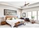 Bright main bedroom with a ceiling fan, wood accents, and stylish decor at 5917 Black Forest Dr, Elizabeth, CO 80107