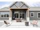 Covered patio featuring a centered dining table and a comfortable seating area with a fire pit at 5917 Black Forest Dr, Elizabeth, CO 80107