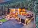 Contemporary home with a private putting green, a fire pit area, a balcony, and an attached garage in a wooded setting at 7793 Elk Path Way, Morrison, CO 80465