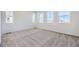 Bright bedroom with plush carpeting and multiple windows, providing natural light and a view of the outdoors at 1961 S Haleyville Way, Aurora, CO 80018