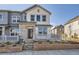Charming townhome featuring a stone facade and inviting front porch, perfect for enjoying the neighborhood views at 1961 S Haleyville Way, Aurora, CO 80018