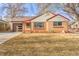 Brick ranch home with a landscaped yard and attached garage at 2995 Ivanhoe St, Denver, CO 80207