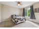 Comfortable bedroom with a ceiling fan and large window providing natural light at 7126 E 162Nd Ct, Brighton, CO 80602
