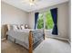 Inviting bedroom with a window and blue curtains, offering a peaceful retreat at 7126 E 162Nd Ct, Brighton, CO 80602