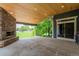 Covered patio with a fireplace, providing a comfortable spot for outdoor entertaining at 7126 E 162Nd Ct, Brighton, CO 80602