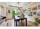 Bright dining room with hardwood floors, unique lighting fixture, and a wall of art, ideal for entertaining at 7126 E 162Nd Ct, Brighton, CO 80602