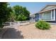 Charming home exterior with blue siding, well-maintained landscaping, and a white fence at 7126 E 162Nd Ct, Brighton, CO 80602