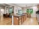 Open kitchen featuring an island with cooktop, granite countertops, and hardwood floors at 7126 E 162Nd Ct, Brighton, CO 80602