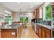 Spacious kitchen with wooden cabinets, granite countertops, and modern appliances at 7126 E 162Nd Ct, Brighton, CO 80602