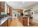 Kitchen with hardwood floors, wood cabinets, granite countertops, stainless appliances, and island with cooktop at 7126 E 162Nd Ct, Brighton, CO 80602