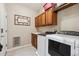 Practical laundry room with washer, dryer, cabinetry, and a utility sink at 7126 E 162Nd Ct, Brighton, CO 80602