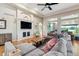 Cozy living room with a fireplace, hardwood floors, and ample natural light at 7126 E 162Nd Ct, Brighton, CO 80602