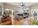Spacious living room with hardwood floors, a ceiling fan, and an open layout at 7126 E 162Nd Ct, Brighton, CO 80602