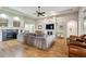 Bright living room with hardwood floors, a fireplace, and comfortable furnishings at 7126 E 162Nd Ct, Brighton, CO 80602