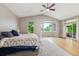 Bright main bedroom with large windows, vaulted ceiling, and access to outdoor patio at 7126 E 162Nd Ct, Brighton, CO 80602