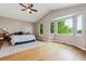 Main bedroom featuring high ceilings, a large bay window, hardwood floors, and a ceiling fan at 7126 E 162Nd Ct, Brighton, CO 80602