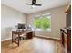 Home office featuring hardwood floors, a ceiling fan and a large window at 7126 E 162Nd Ct, Brighton, CO 80602