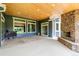Covered patio with a stone fireplace, offering outdoor living space at 7126 E 162Nd Ct, Brighton, CO 80602
