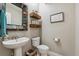 Stylish powder room with vessel sink, unique mirror and floating shelves at 7126 E 162Nd Ct, Brighton, CO 80602