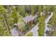 Drone shot of mountain home with wooded surroundings and a long private drive at 1152 Ski Hill Rd, Breckenridge, CO 80424