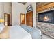 Bright bedroom features a stone fireplace and closet at 1152 Ski Hill Rd, Breckenridge, CO 80424