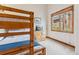 Bedroom with bunkbeds, a small dresser, and a wooden-framed window at 1152 Ski Hill Rd, Breckenridge, CO 80424