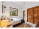 Bright bedroom featuring a queen bed, wood accents, and exterior views at 1152 Ski Hill Rd, Breckenridge, CO 80424