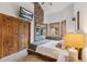 Bedroom with stone fireplace and wall mounted TV at 1152 Ski Hill Rd, Breckenridge, CO 80424