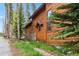 Side exterior of the home featuring wood siding and stone accents at 1152 Ski Hill Rd, Breckenridge, CO 80424