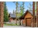 Stunning exterior view showcasing multiple garages and covered carport framed by majestic mountains at 1152 Ski Hill Rd, Breckenridge, CO 80424