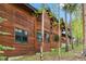 Close exterior view of a wood cabin highlighting its natural wood grain and green framed windows at 1152 Ski Hill Rd, Breckenridge, CO 80424