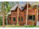 Scenic view of wood cabin showing layered architectural design accented by green trim and natural wood grain at 1152 Ski Hill Rd, Breckenridge, CO 80424
