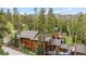 Stunning mountain home with lush forestry and snow-capped peaks in the distance at 1152 Ski Hill Rd, Breckenridge, CO 80424