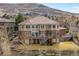 This aerial view shows a large, multi-story home with well-manicured lawn at 132 Loveland Way, Golden, CO 80401