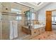 Bathroom featuring a walk-in shower, a soaking tub, and tiled walls at 132 Loveland Way, Golden, CO 80401