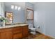 Powder room featuring granite counters, wood floors, and a matching wood vanity at 132 Loveland Way, Golden, CO 80401