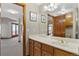 Bright bathroom features a vanity with wood cabinets, white countertops, and classic fixtures at 132 Loveland Way, Golden, CO 80401