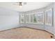 Bedroom with a ceiling fan, neutral walls, carpet, and windows with wooden trim at 132 Loveland Way, Golden, CO 80401