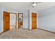 Bedroom with a ceiling fan, neutral walls, carpet, and view to an en-suite bathroom at 132 Loveland Way, Golden, CO 80401