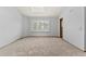 Empty bedroom with neutral carpet, window with shutters, and fresh paint at 132 Loveland Way, Golden, CO 80401