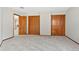 Bedroom features neutral colored walls, plush carpet, and three wooden closets at 132 Loveland Way, Golden, CO 80401