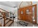 Bright foyer with tile flooring, a staircase, and a view into the living area with a fireplace and comfortable seating at 132 Loveland Way, Golden, CO 80401